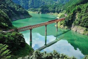 This beautiful railway bridge is built over a mountain reservoir in the Southern Japanese Alps, in Shizuoka Prefecture.
