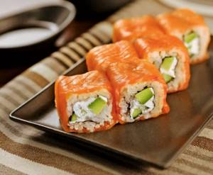 sushi rolls as eaten with chopsticks